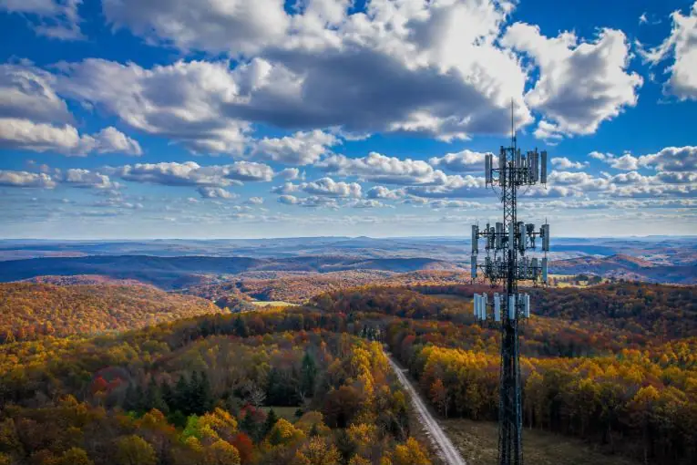 A transmission tower above rolling hills
